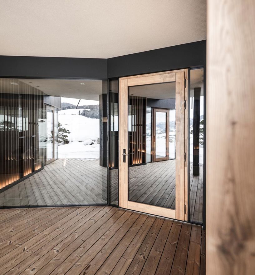 Moderne Glastür mit Holzrahmen in klarer, minimalistischer Architektur.